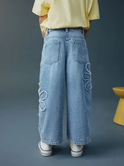 Next Bleu moyen - Jean Jambe large Fleuri (3-16ans)