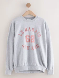 Next Gris - Sweat-shirt à col rond à manches longues en satin appliqué 'Le Marais' City Best